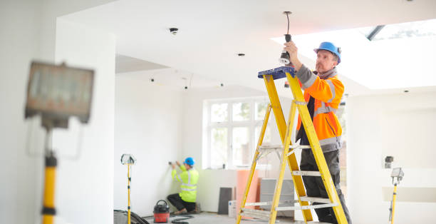 electrician installing downlights
